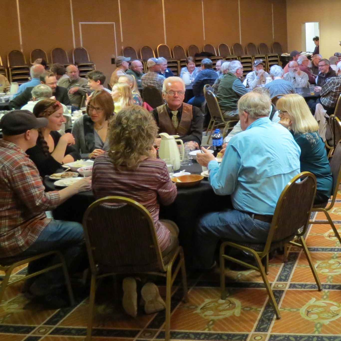 Room full of people at HFFA Annual meetingsitting at tables.