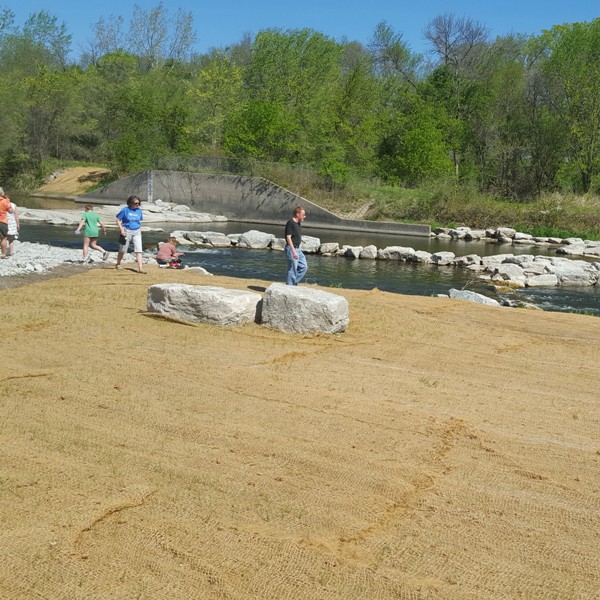 Stream restoration with large rocks and landscape fabric on Skunk river Project in Ames.